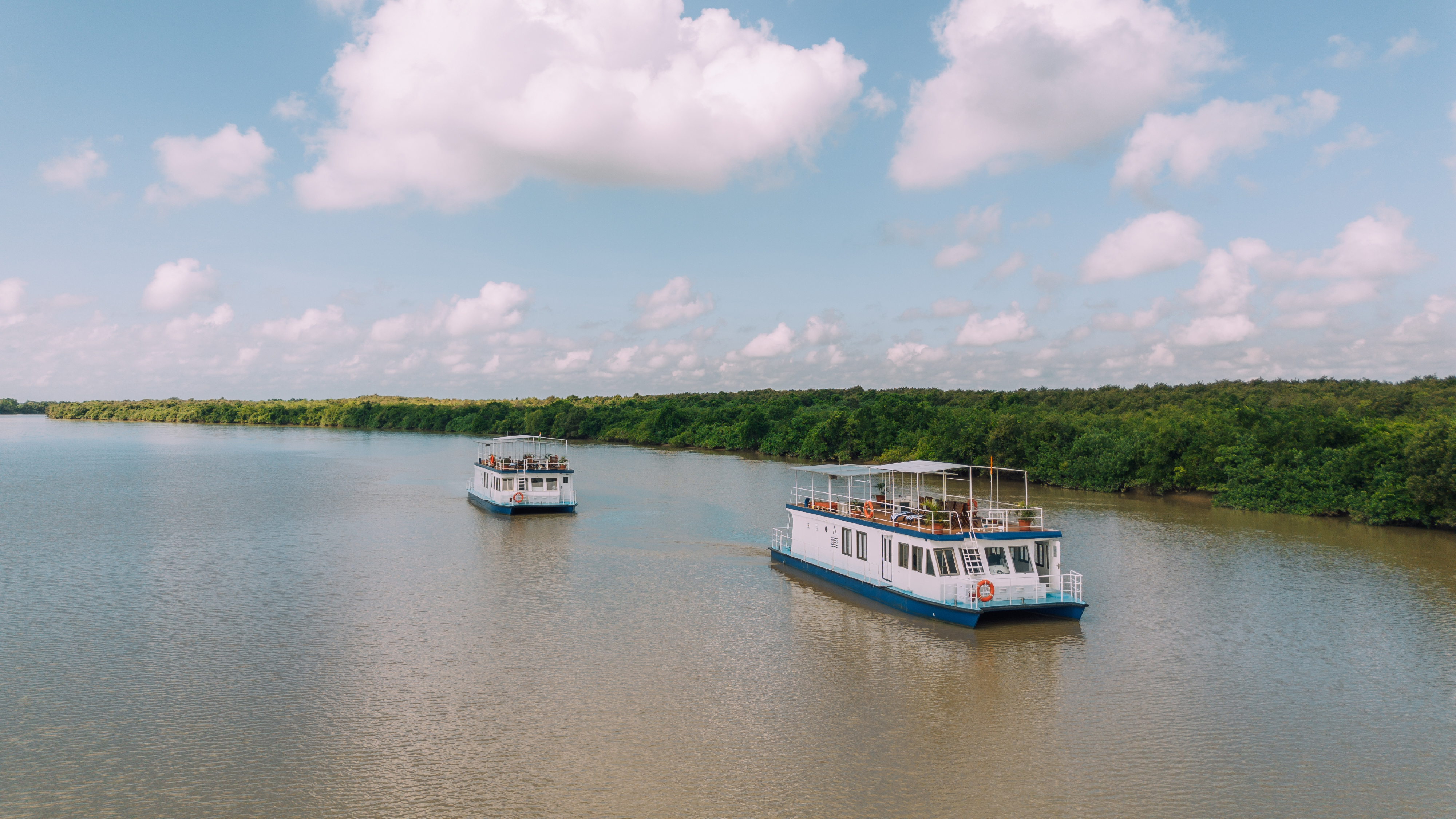 Luxury catamaran sailing through Bhitarkanika mangrove creeks